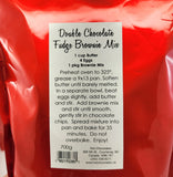 A red plastic bag of Hot Chocolates Artisan Double Chocolate Fudge Brownie Mix, showing the back of the package with a white label containing baking instructions and ingredients.