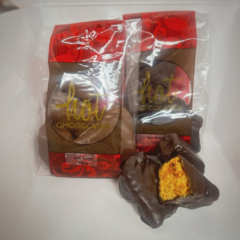 Packaged artisan chocolate dipped Sponge Toffee, house-made, called Sea Foam, displayed on a white surface.