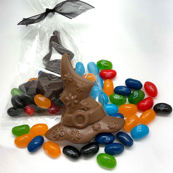 2 chocolate sorting hats with colourful jelly belly beans around them, the dark chocolate hat in a clear bag with a black ribbon tie.