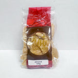 A red, brown and clear package showing golden artisan brittle with freshly roasted nuts, labeled 'Almond 125g'.