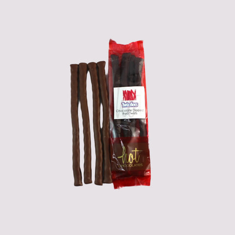 An image showing artisan chocolate dipped licorice in a package reading 'Twizzlers Chocolate Dipped Red Twists' in red packaging with a gold logo.