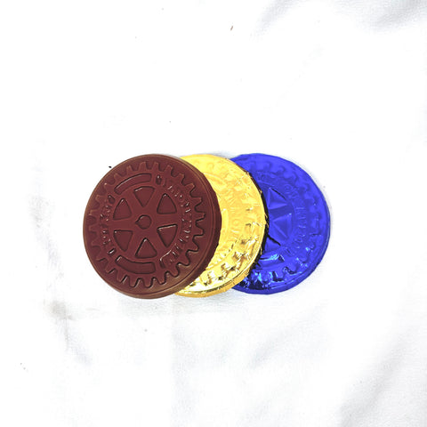 Three solid chocolate Rotary International coins with gold and blue foils and a rotary design embossed on the front, placed on a white surface. Crafted in Canada.