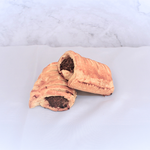 2 gourmet all-beef sausage rolls on a white background, with a beautiful golden crust and dark meat filling.