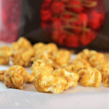 A close-up of Hot Chocolates artisan caramel popcorn selection in individual pieces with a blurred background.