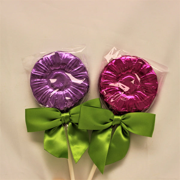 2 milk chocolate flower lollipop suckers foiled in bright purples, finished with a vibrant green bow on each.