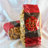 2 red and brown bags filled with dairy free caramel popcorn from Hot Chocolates.