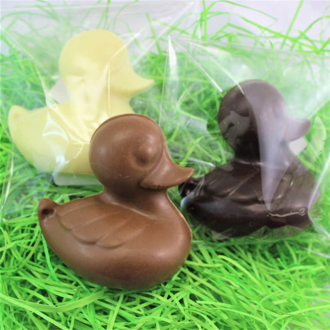 A solid chocolate Easter duckling named Duckie shown in mild, dark and white chocolate.