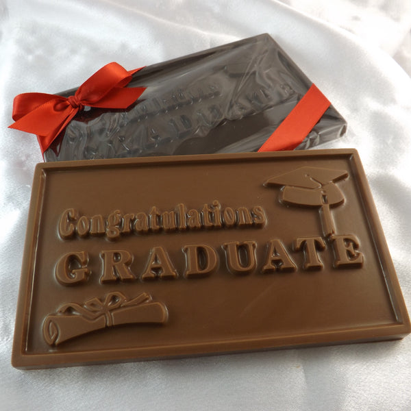 A solid chocolate gift bar with a grad cap and scroll, and text that read 'congratulations graduate' embossed on the front.