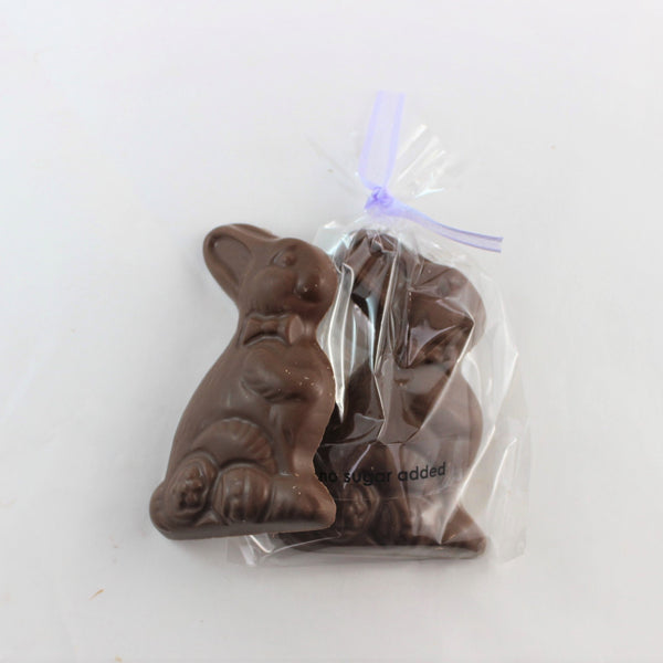 Little Bunny is a no sugar added chocolate easter bunny shape with a purple ribbon attached, wrapped in a clear plastic packaging with 'NSA added' text visible.