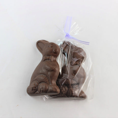 Little Bunny is a no sugar added chocolate easter bunny shape with a purple ribbon attached, wrapped in a clear plastic packaging with 'NSA added' text visible.