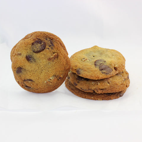 A stack of butter pecan chocolate chunk cookies on a white background.