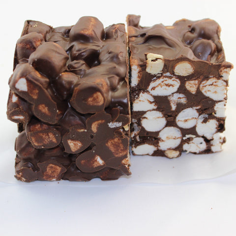 A gourmet chocolate marshmallow nut square called Rocky Road with visible roasted nuts and marshmallows throughout.
