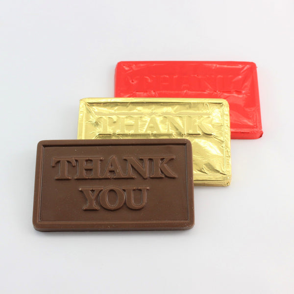 Foiled chocolate thank you bars, in gold and red, with an unwrapped example in the front.