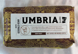 A brown bag with gold highlights filled with dark roast coffee beans from Caffe Umbria, labeled 'best for brewed coffee'.