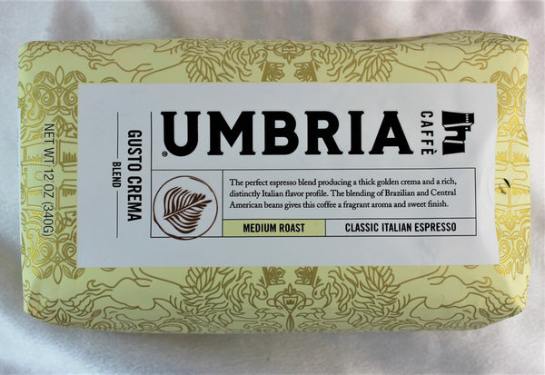 A cream coloured bag of coffee beans labeled classic Italian Espresso, medium roast from Caffe Umbria.