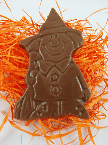 A Happy Halloween Chocolate Witch, placed on a bed of orange crumpled shred.