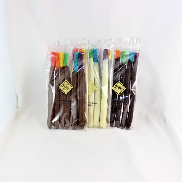 Packaged chocolate dipped rainbow licorice in transparent wrapping with visible colorful stripes.