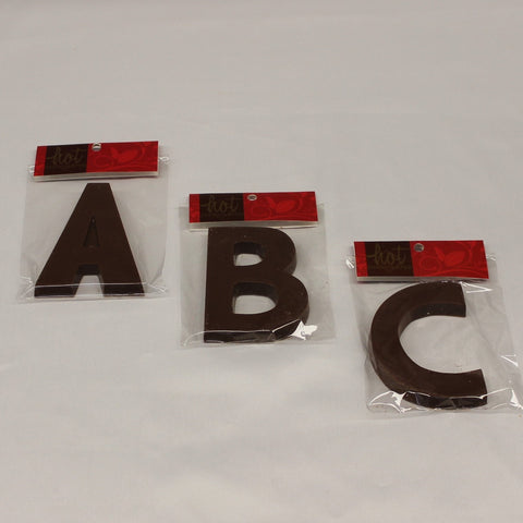 Packaged solid single origin milk chocolate letters 'A', 'B', and 'C' displayed on a white surface.