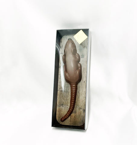 An image showing a Chocolate Rat Halloween Gift Box, with a black and gold box with a clear top, showing a chocolate rat inside, on a white background.