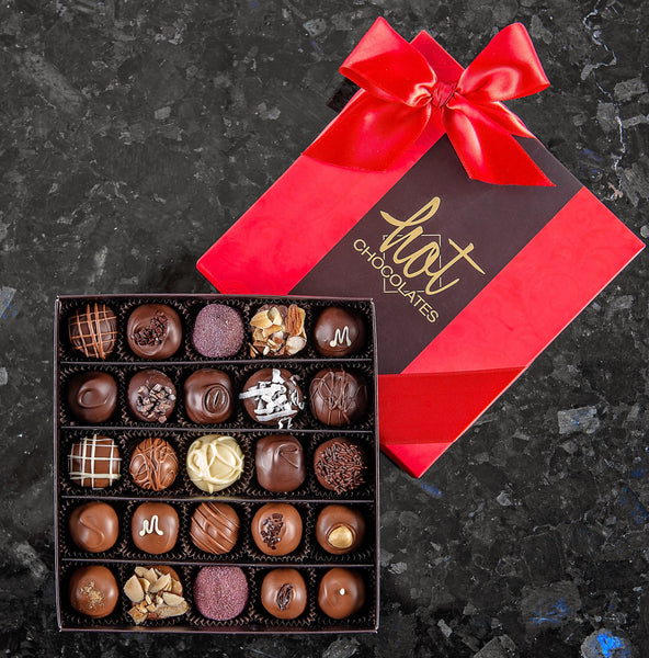 A box of 25 hand-dipped chocolate truffles with assorted fillings, presented in a brown and red box with a red bow on top.