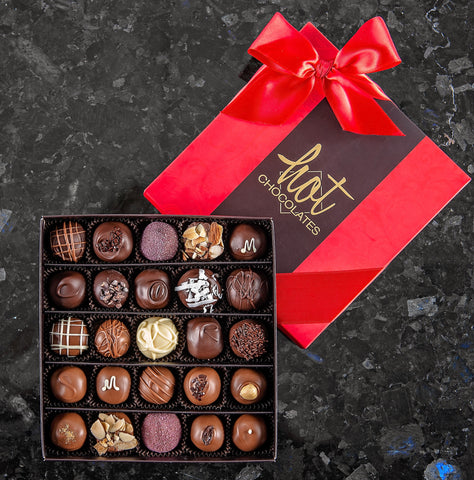 A box of 25 hand-dipped chocolate truffles with assorted fillings, presented in a brown and red box with a red bow on top.
