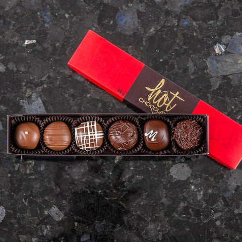 6 assorted hand-dipped chocolate truffles in a sleeve style box with 'Hot Chocolates' branding.
