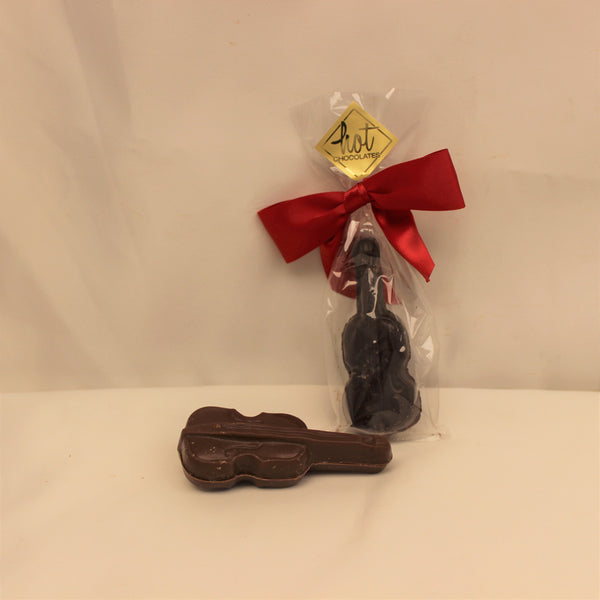 A single origin chocolate violin, laying on a white background with a packaged one upright with a red bow.