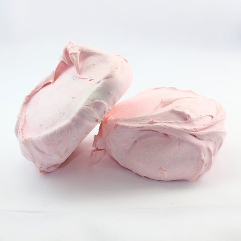 Two pink classic seasonal flavoured meringue cookies on a white background, these in strawberry flavour.