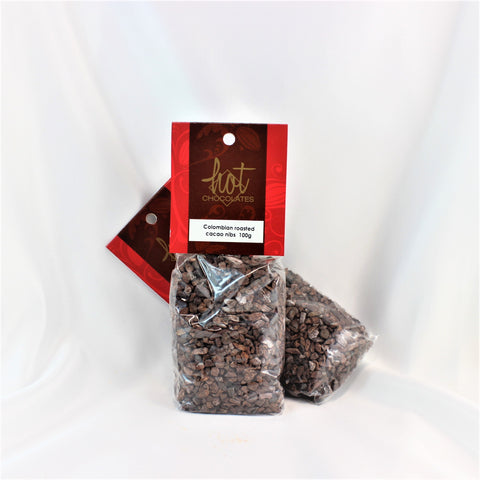 2 clear bags with red and brown labels filled with roasted single origin Colombian cacao nibs. 