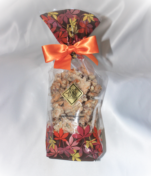 A autumn themed bag with an orange bow filled with an artisan white chocolate snack mix called Courtenay Compost, named for Courtenay, BC Canada.