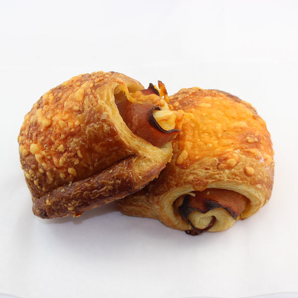 2 maple ham cheddar cheese croissant rolls, on a white backgrpound.